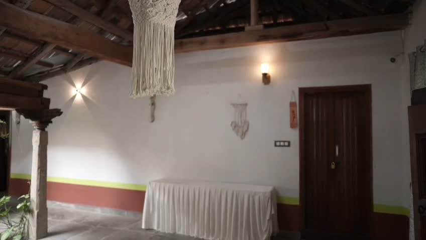 Traditional wooden beam architecture, stone pillars, and courtyard hall inside Thottimane